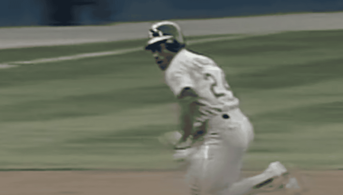 Rickey Henderson stealing a base, showcasing his speed and impact as a leadoff hitter.